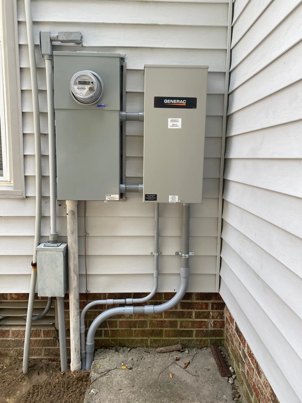 Generac transfer switch installed beside a home's meter